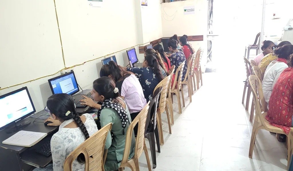 Women practicing computer skills in a CWS learning center